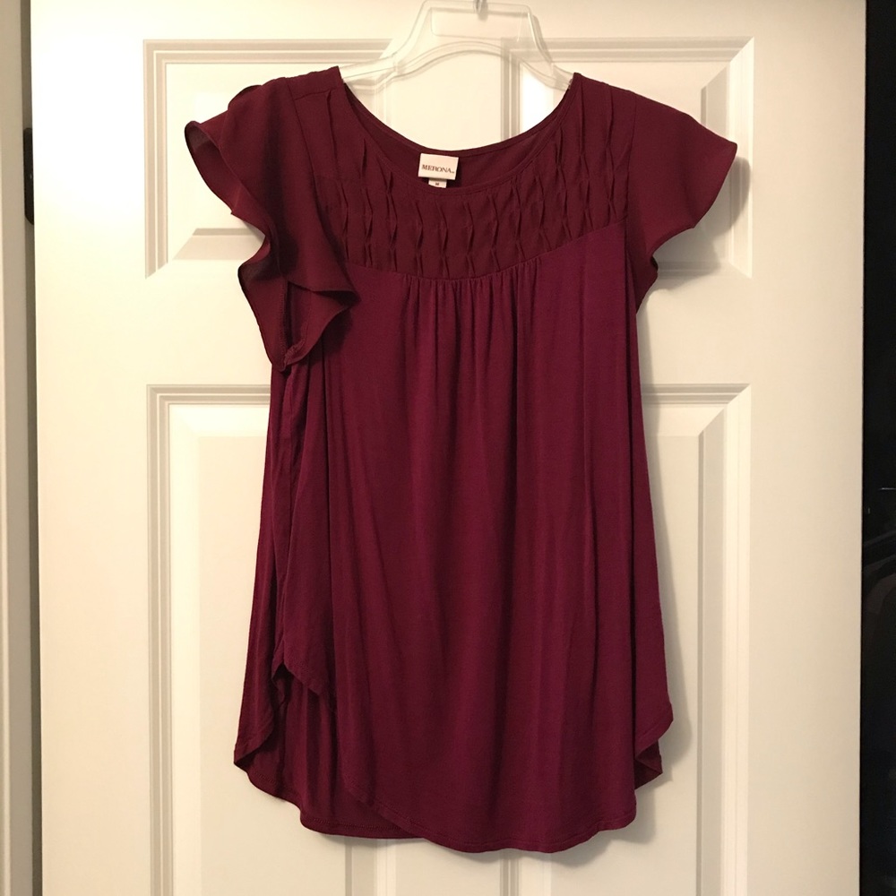Women’s deep magenta flutter sleeve blouse.